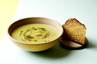 Photograph of a bowl of soup with bread.