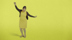A person in a yellow dress dances in a yellow room
