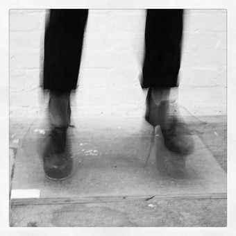 Black and white photo of feet blurred and in-motion.
