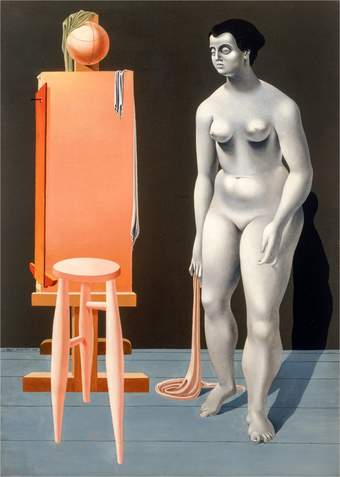 nude woman with dark hair stood beside an empty easel