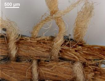 Close-up image of woven fabrics, showing the combination of thicker strands and thinner threads