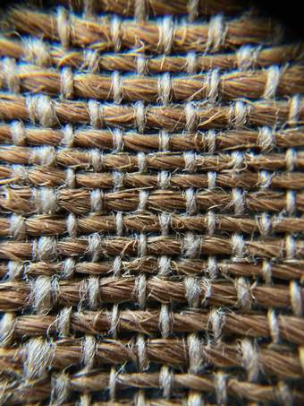 Close-up image of woven fabrics, showing the combination of thicker strands and thinner threads