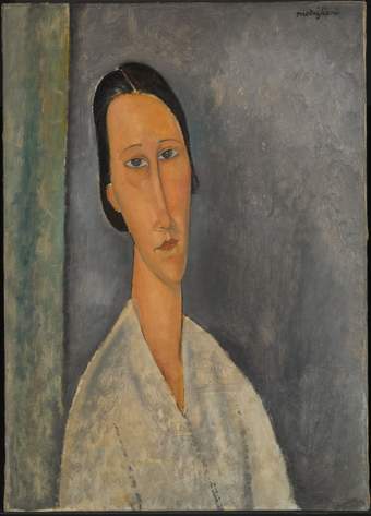 Head-and-shoulders portrait of Madame Zborowska, her body slightly turned to the right, her head turned to face the viewer. Short dark hair. Elongated neck, head and facial features. She wears simple light-coloured clothing.
