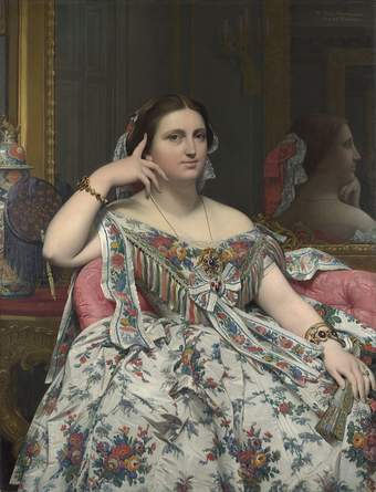 Portrait of a seated woman, her right arm resting on the back of her seat, the finger of that hand resting against her head while the other hand rests on her lap. She wears a voluminous floral gown cut low on the shoulders.