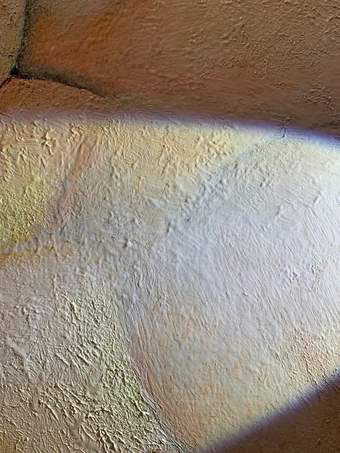 Very close detail of area of pale white skin showing the texture of the paint surface