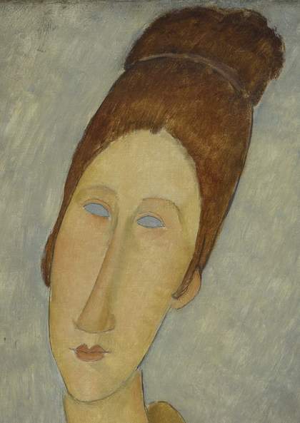 Close-up detail of the face and hair in normal light, showing the smooth finish of the skin on the face