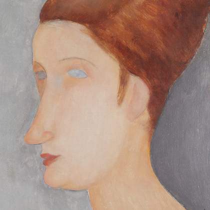 Close-up detail of the face and hair in normal light, showing the smooth finish of the skin on the face, especially across the cheek and the soft chin