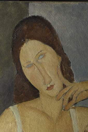Detail of the face and shoulders, with the figure’s right index finger resting against her cheek, the other fingers below