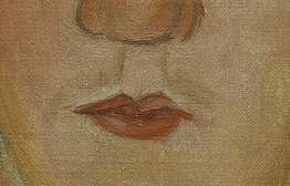 Detail of the small, pursed mouth. Deep red with pointed ‘cupid’s bow’. A faint, light brown moustache visible above.