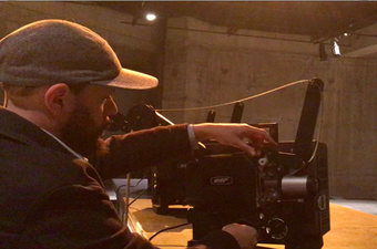 Close-up of a person adjusting a film projector