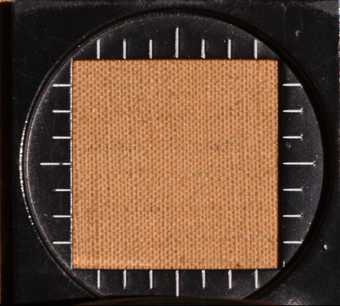 Close-up image of the canvas textile showing the dense weave; photographed through a square window tool showing scale.