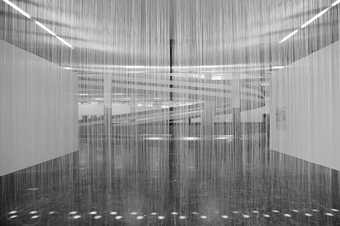 Black-and-white installation photograph showing the many thin nylon threads running vertically across the exhibition space, creating a kind of ethereal veil
