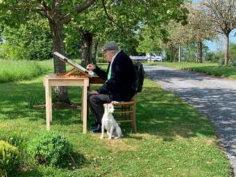 David Hockney drawing with his dog Ruby in the garden of his home in Normandy, France, 29 April 2020.