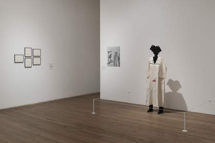 installation image of the Huguette Caland's display which shows a sculpture of a figure