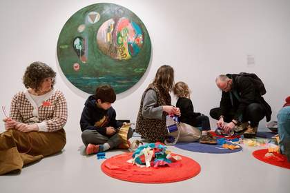 Children and adults making wearable art in the Bharti Kher exhibition