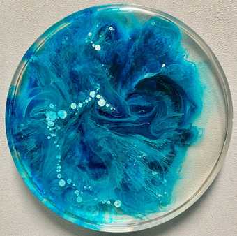 a glass dish with bright blue wave like patten inside it