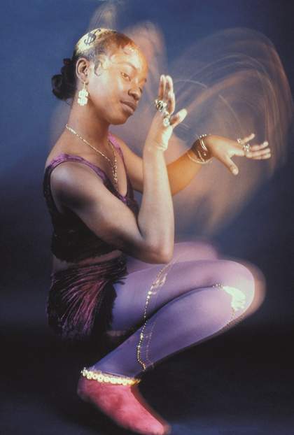 a woman crouches down on the floor