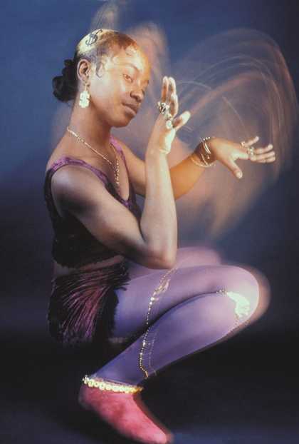 a woman crouches down on the floor