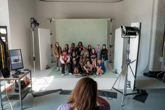 A group of young people posing in a photo studio