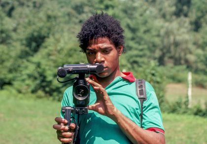 Artist Jean-Michel Basquiat holds a film camera
