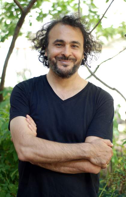 A head shot of artist Kader Attia
