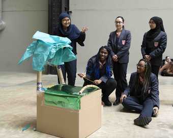 Five students present their sculpture made collaboratively as part of a workshop