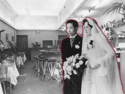 Black and white photograph of an empty restaurant with tables, chairs and a bar. Overlaid is an image of a Chinese man and white woman in a wedding dress, bordered by red thread.