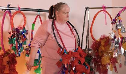 Artist Linda Bell activates her hoop sculptures by throwing them from hand to hand in a studio space