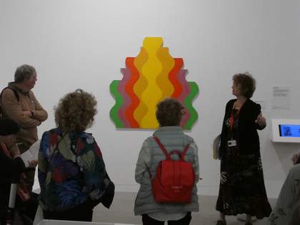 A group of three people listening to a talk by specialist gallery educator Susanna Webster