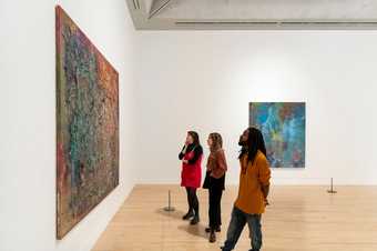 People look at a Frank Bowling artwork in Tate Britain