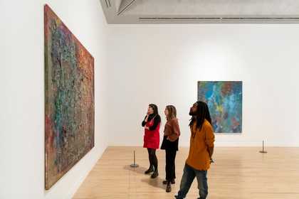 People look at a Frank Bowling artwork in Tate Britain