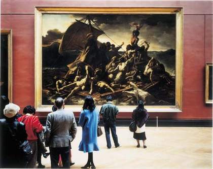 People looking at large painting in a gallery