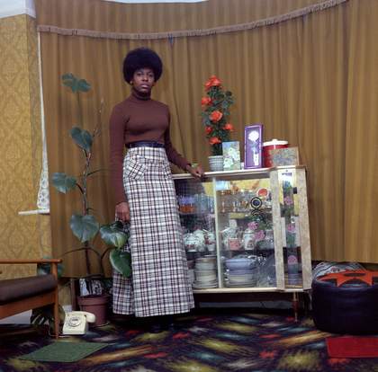 Neil Kenlock Young Jamaican Lady Standing in her Mother’s Front Room in Brixton Hill 1973