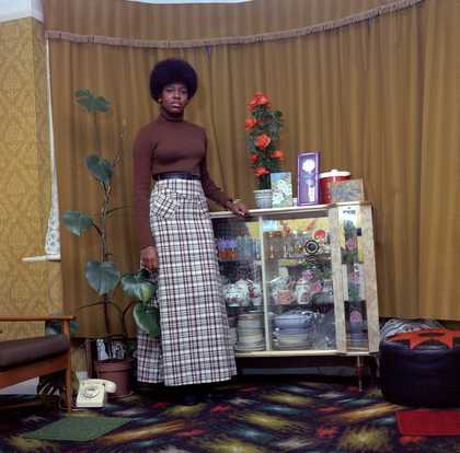 Neil Kenlock Young Jamaican Lady Standing in her Mother’s Front Room in Brixton Hill 1973