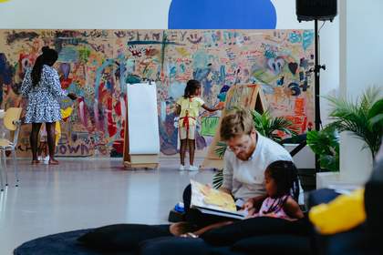 Children painting on a wall in a colourful studio space