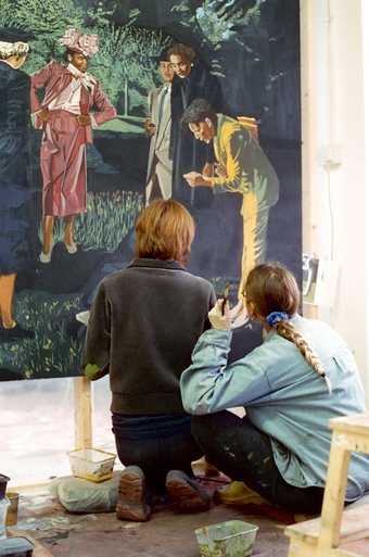 Hannah Quinlan and Rosie Hastings view a partially completed fresco which depicts a group of figures set in a public park