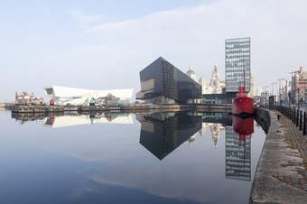 A photograph across Canning Dock in Liverpool towards Mann Island and the Museum of Liverpool and RIBA North.