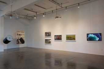 White-walled gallery space with a number of framed artworks on the walls