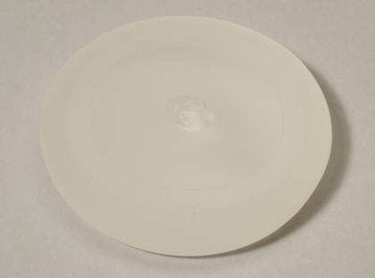 A breast implant on a white surface.