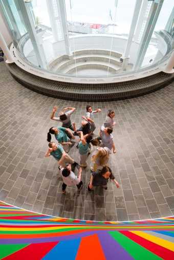 photo shows a group of young people dancing in the gallery