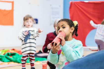 Image of two children playing in the studio in bright colours