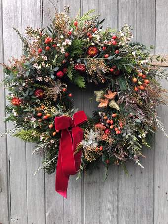 Photograph of a green wreath with a red ribbon