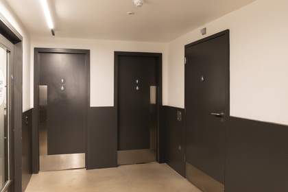 Three closed toilet doors.