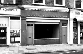 A small building with a sign saying Museum of Installation