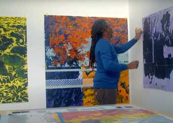 Artist Hurvin Anderson works on one of his artworks in the studio