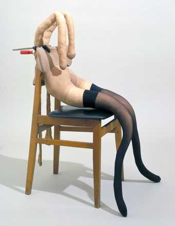 A 'bunny girl' mannequin arranged on a chair. The mannequin wears black tights.