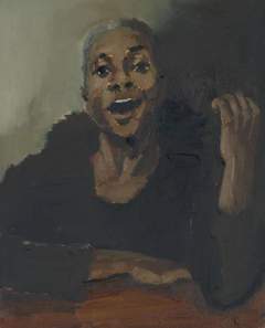 Woman leaning on a table, her mouth open and smiling