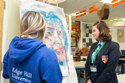 Student and Tackling the Blues ambassador look up at a painted artwork