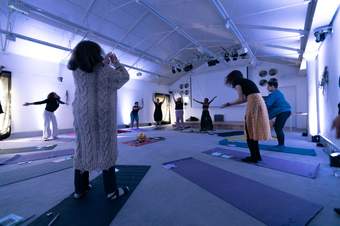 A photograph of people doing yoga at Tate Liverpool.