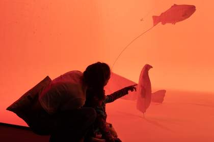 A family look at an installation artwork together.